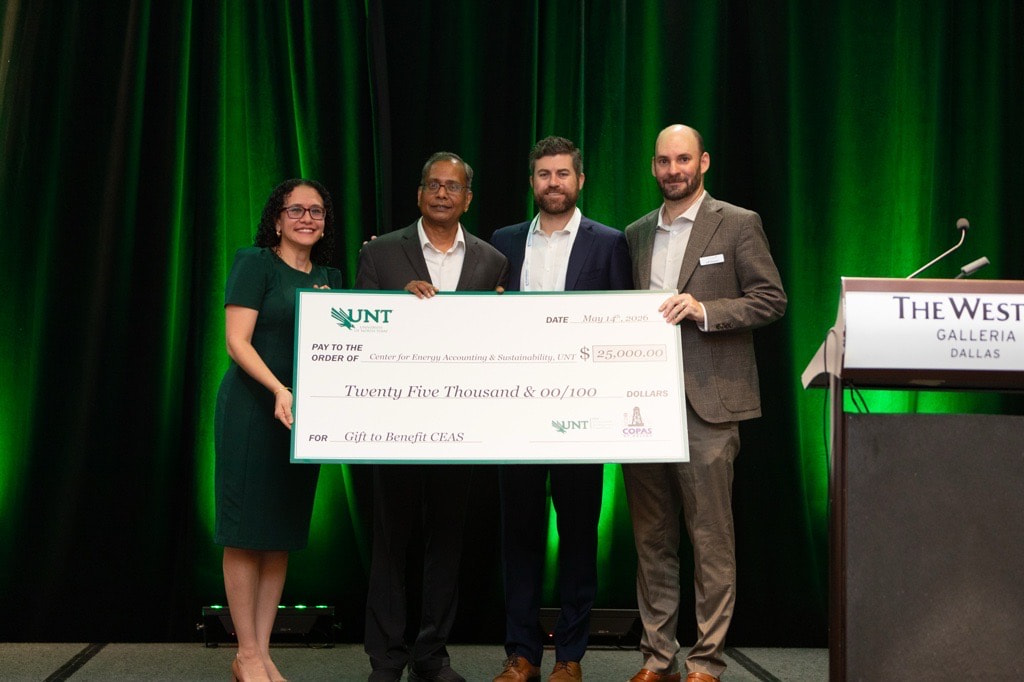 Four people are holding a large check for $25,000.00 made out to the Center for Energy Accounting & Sustainability, UNT. The check is for a gift to benefit CEAS.